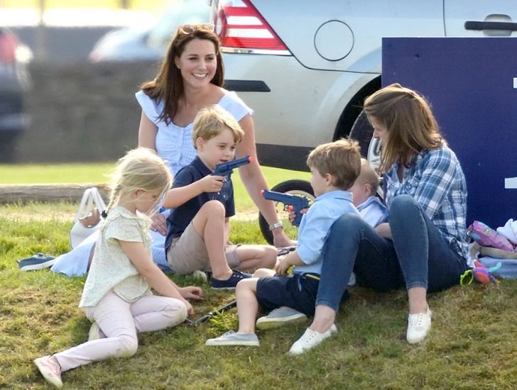 Kate and Lady Laura's children were photographed playing on the ground with their mothers smiling profoundly.